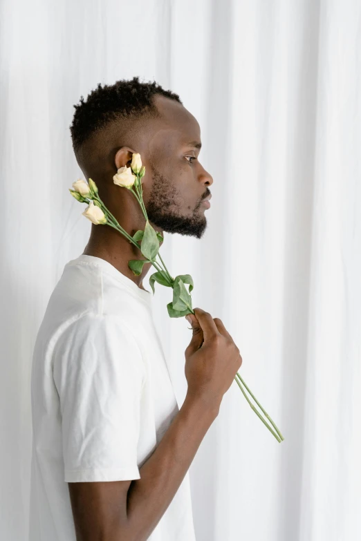 the man has two rose buds on his face