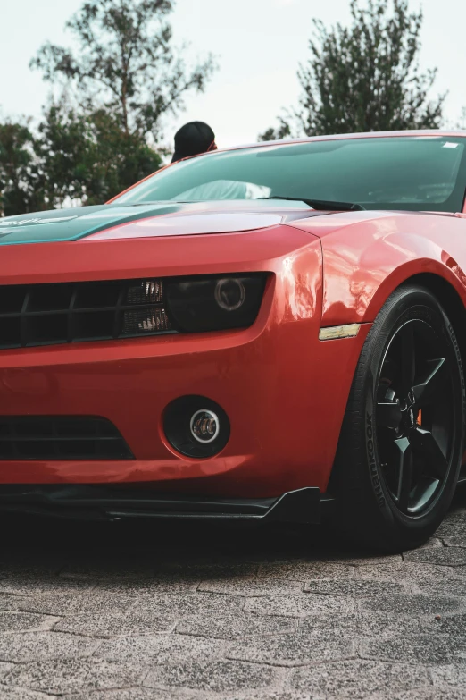 a closeup of the front of a bright red sports car