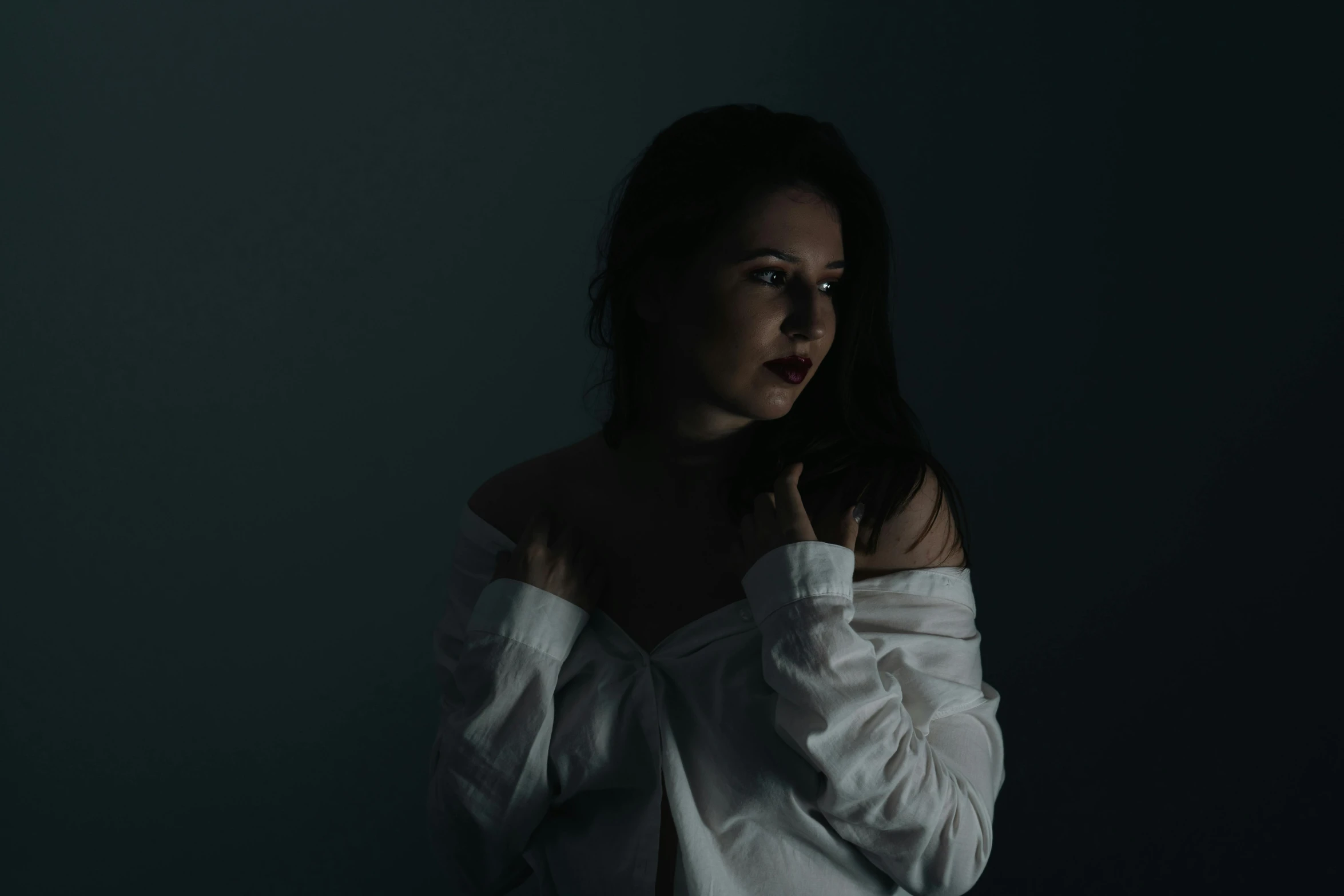 a woman in white is posing for the camera