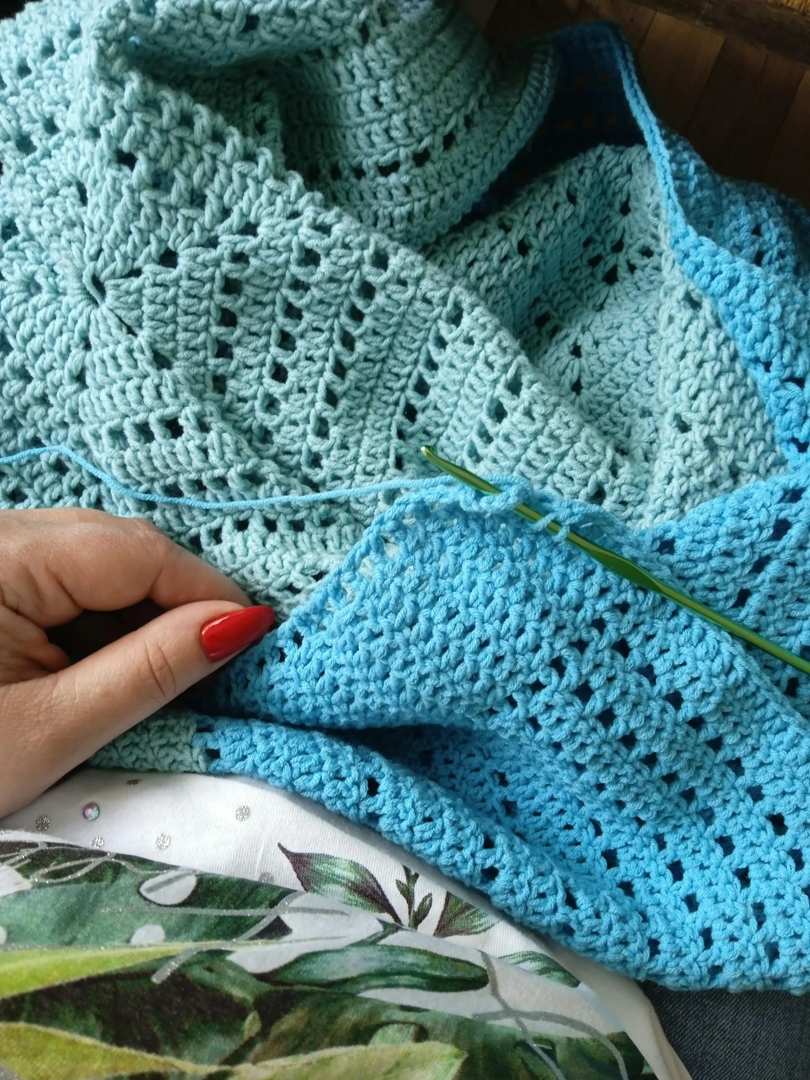 a woman that is using a blue knit blanket