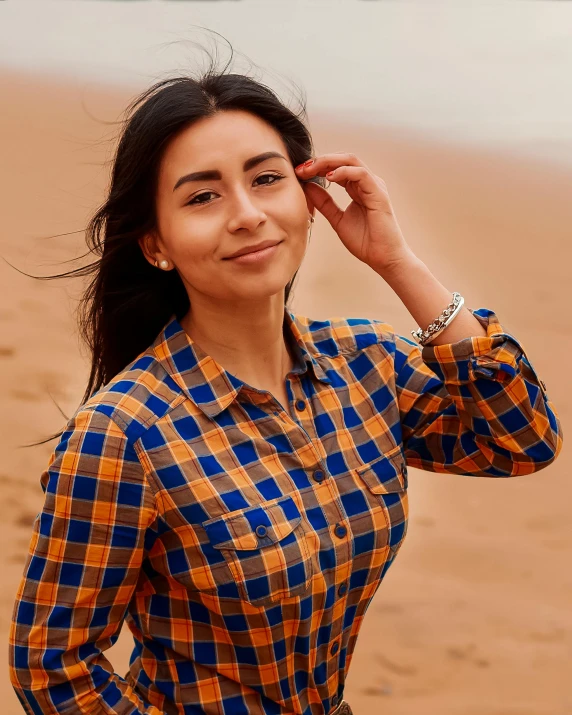 a woman posing for a picture with a hair blowing in the wind