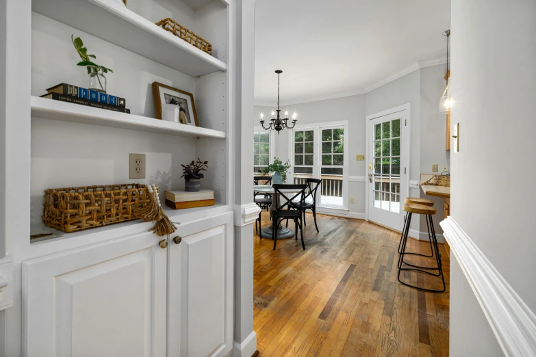 a room with a hard wood floor and a book shelf