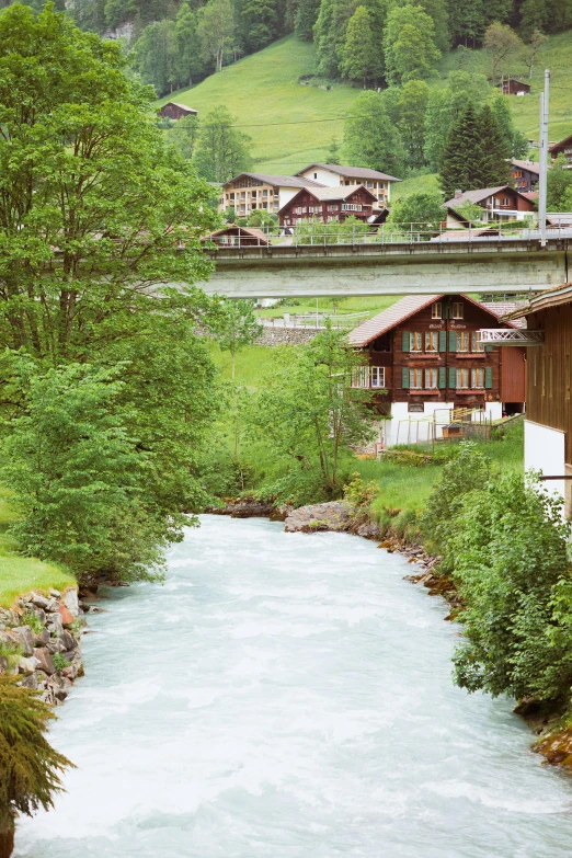 a creek in front of a mountain resort