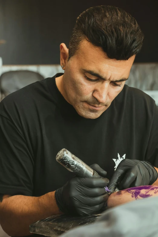 a man getting tattoos done at his job