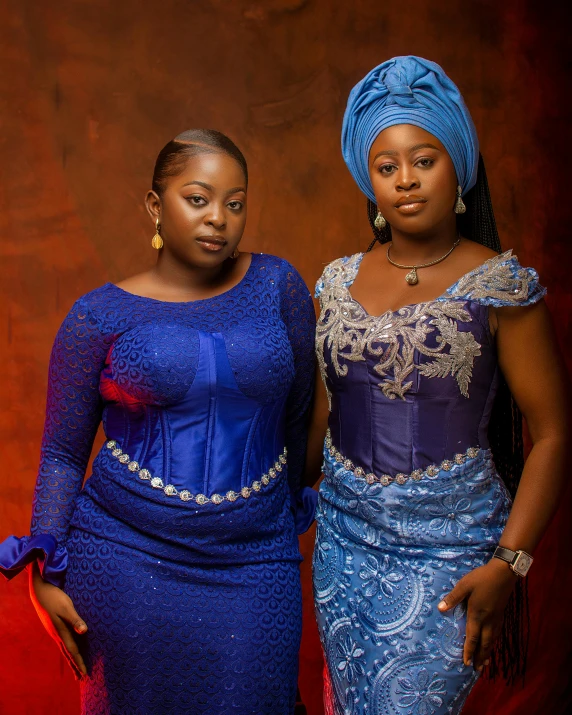two woman in traditional african attire standing together
