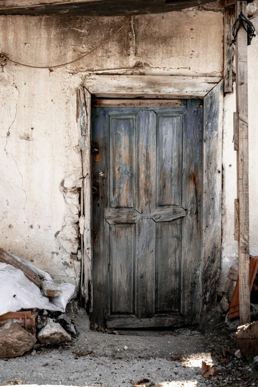 a door and a pile of dirt are on the corner