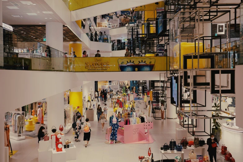 a mall that has several people walking in it