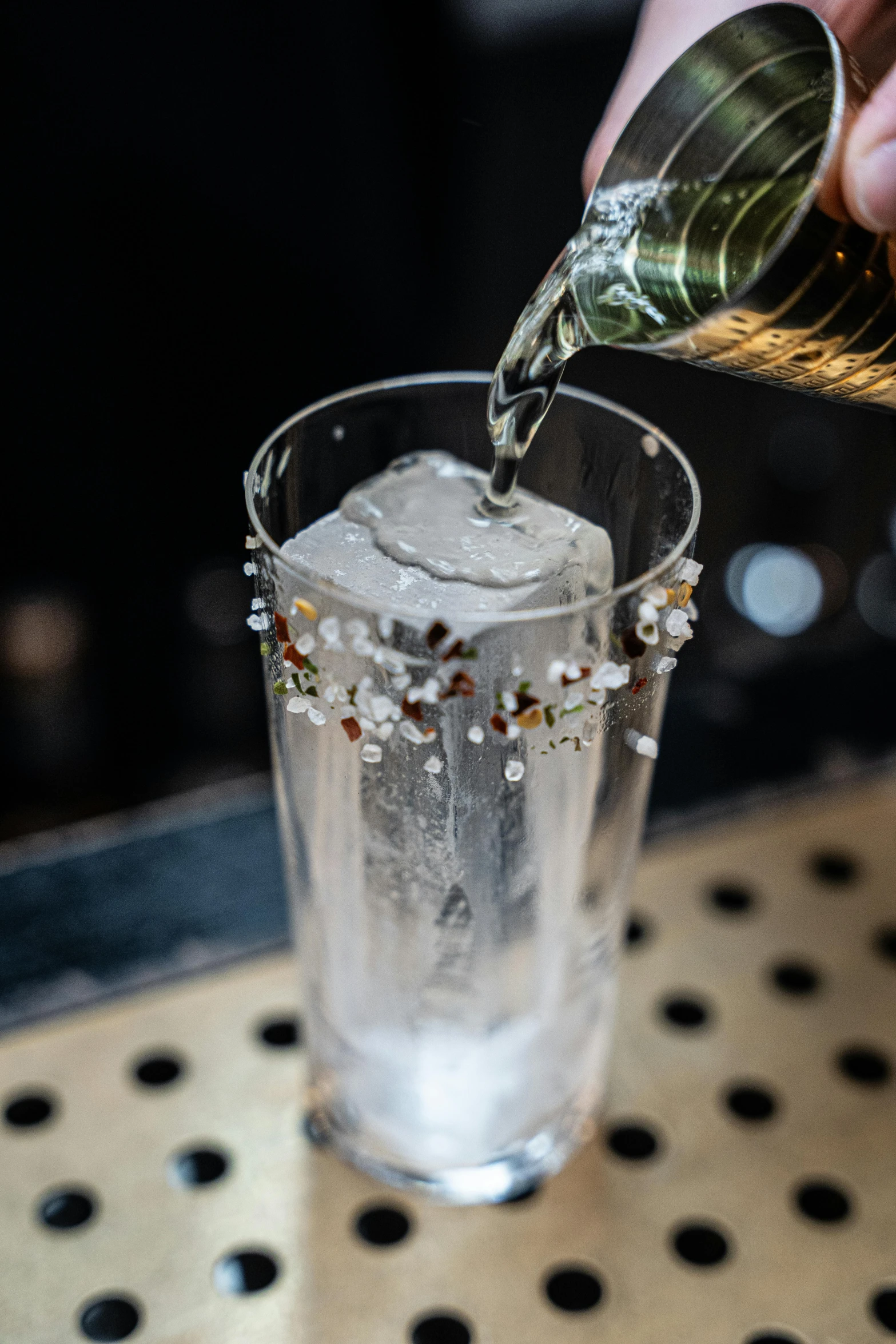 a man pouring an alcoholic drink into a glass