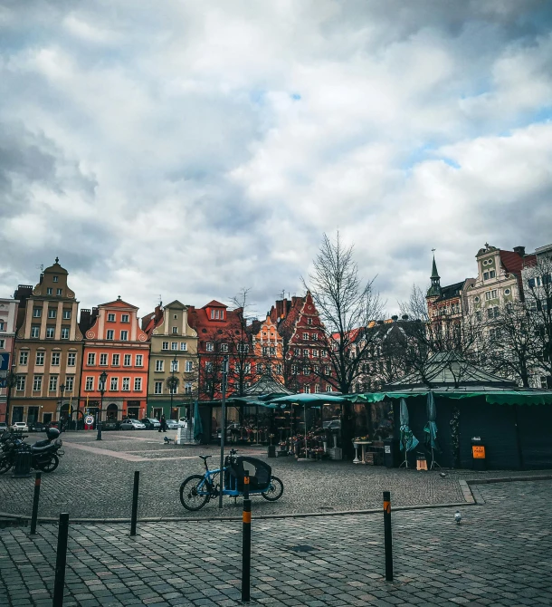 a cobblestone road and a few small buildings