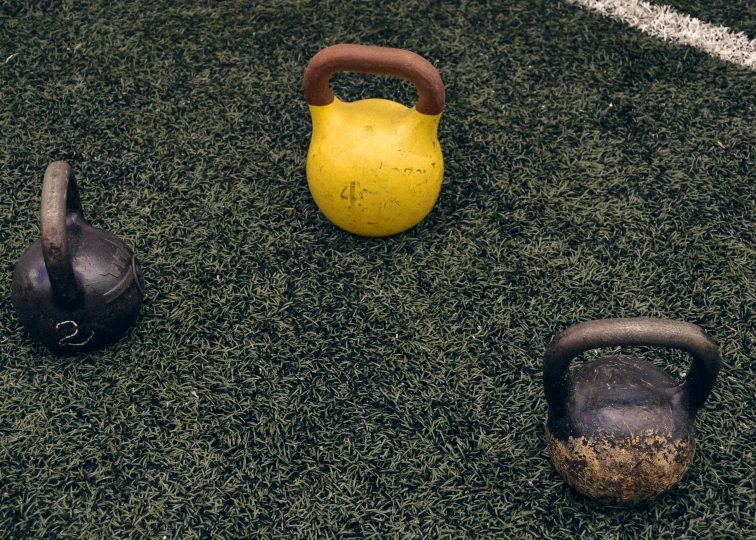 three different pieces of workout equipment on grass