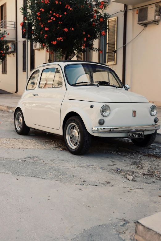 an old alfa car parked on the street