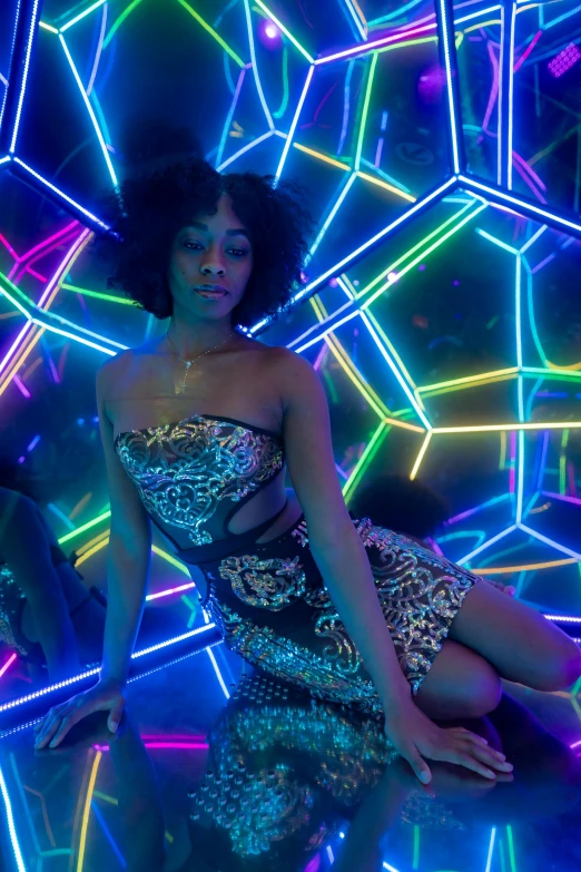 a woman sitting on the ground in a disco dress