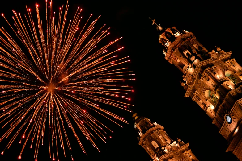 a view of fireworks exploding over a large building