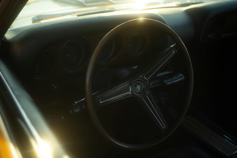 the steering wheel of an old time car is glowing light