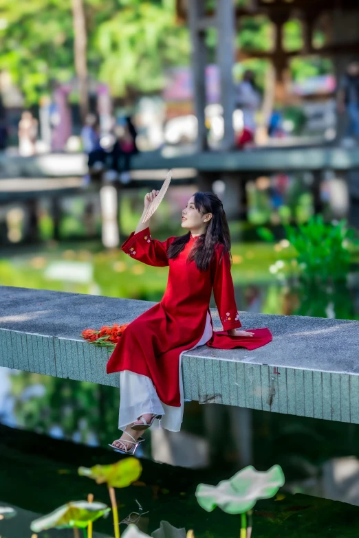 woman in red dress on a pier with flowers