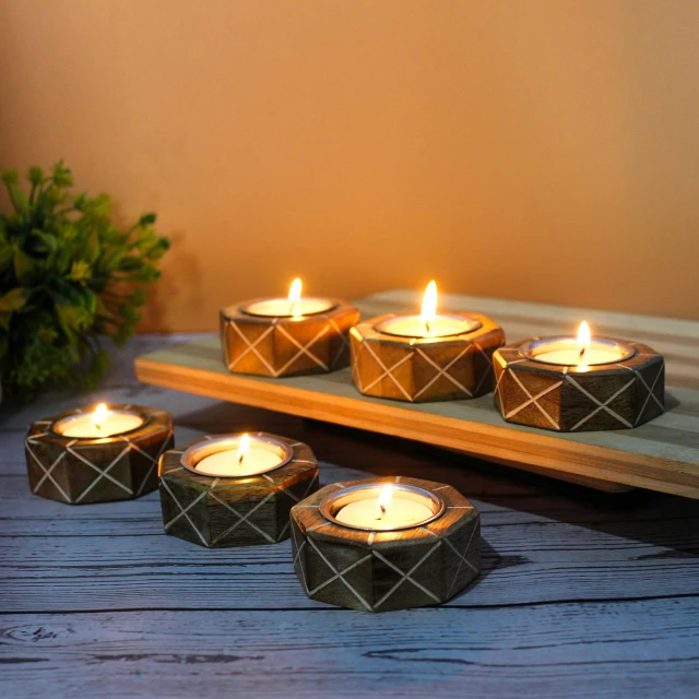 several small tealight candles are sitting on a table