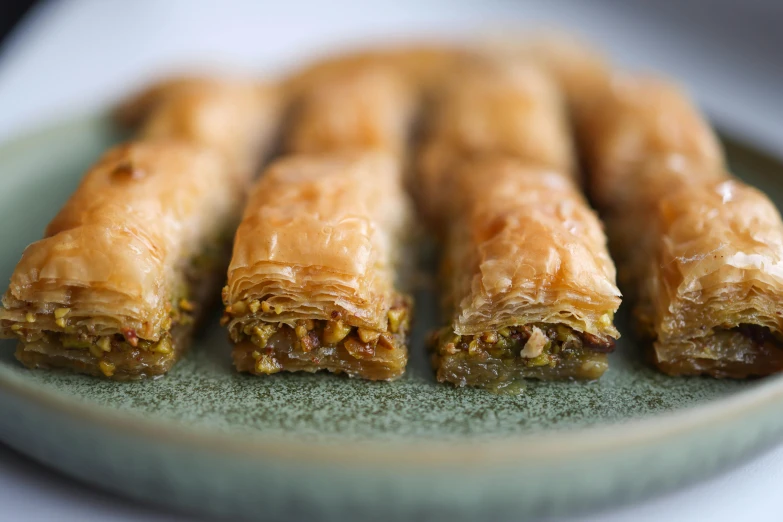 various pastries sitting on a plate with a white table cloth