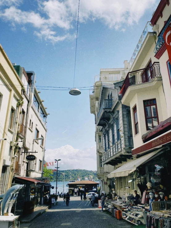 a road that has buildings along side it and a blue sky overhead