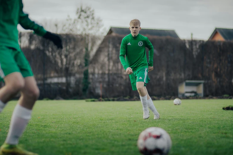 a couple of soccer players are playing on the field