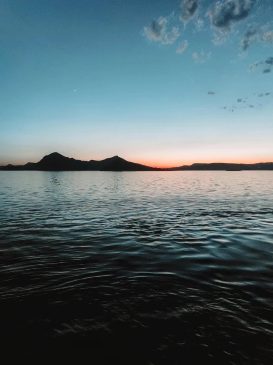 sunset seen from the water of a bay