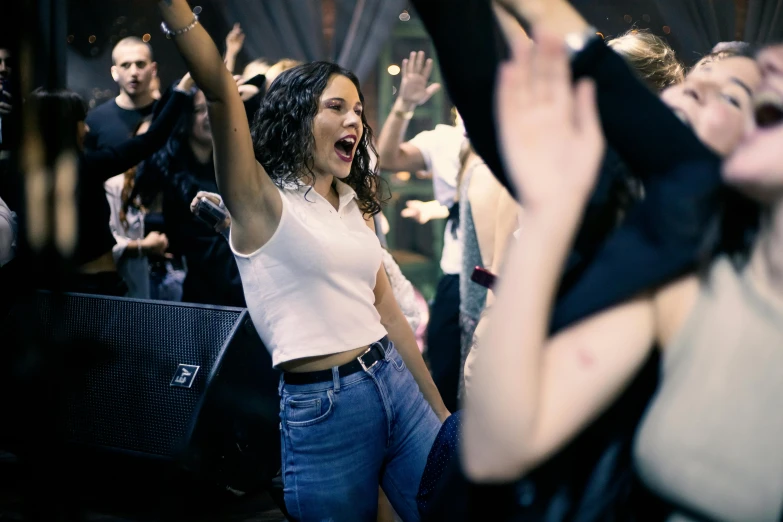 woman with her hands in the air at a concert