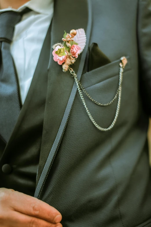 a person wearing a flower clip on their suit