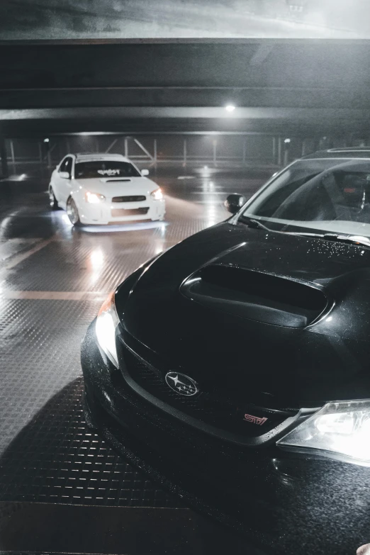 two cars on a street at night