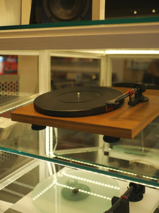 a record player sitting in a glass case