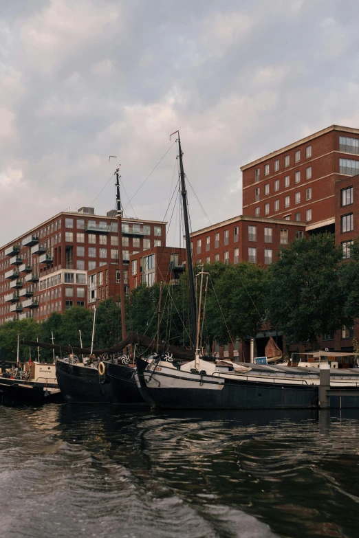 an old fashioned boat with it's sails down on the water