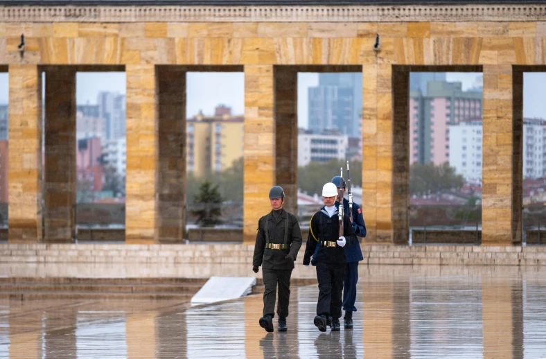 two men walking through the city with their umbrellas