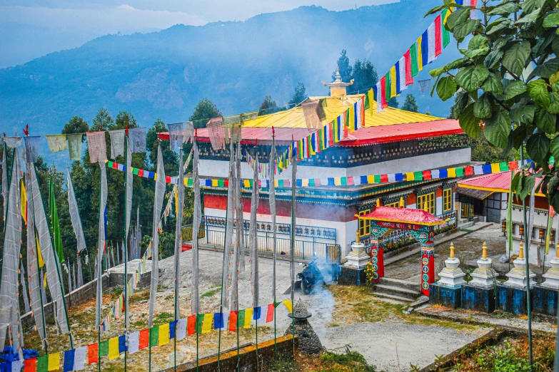 a mountain view with flags flying from a building