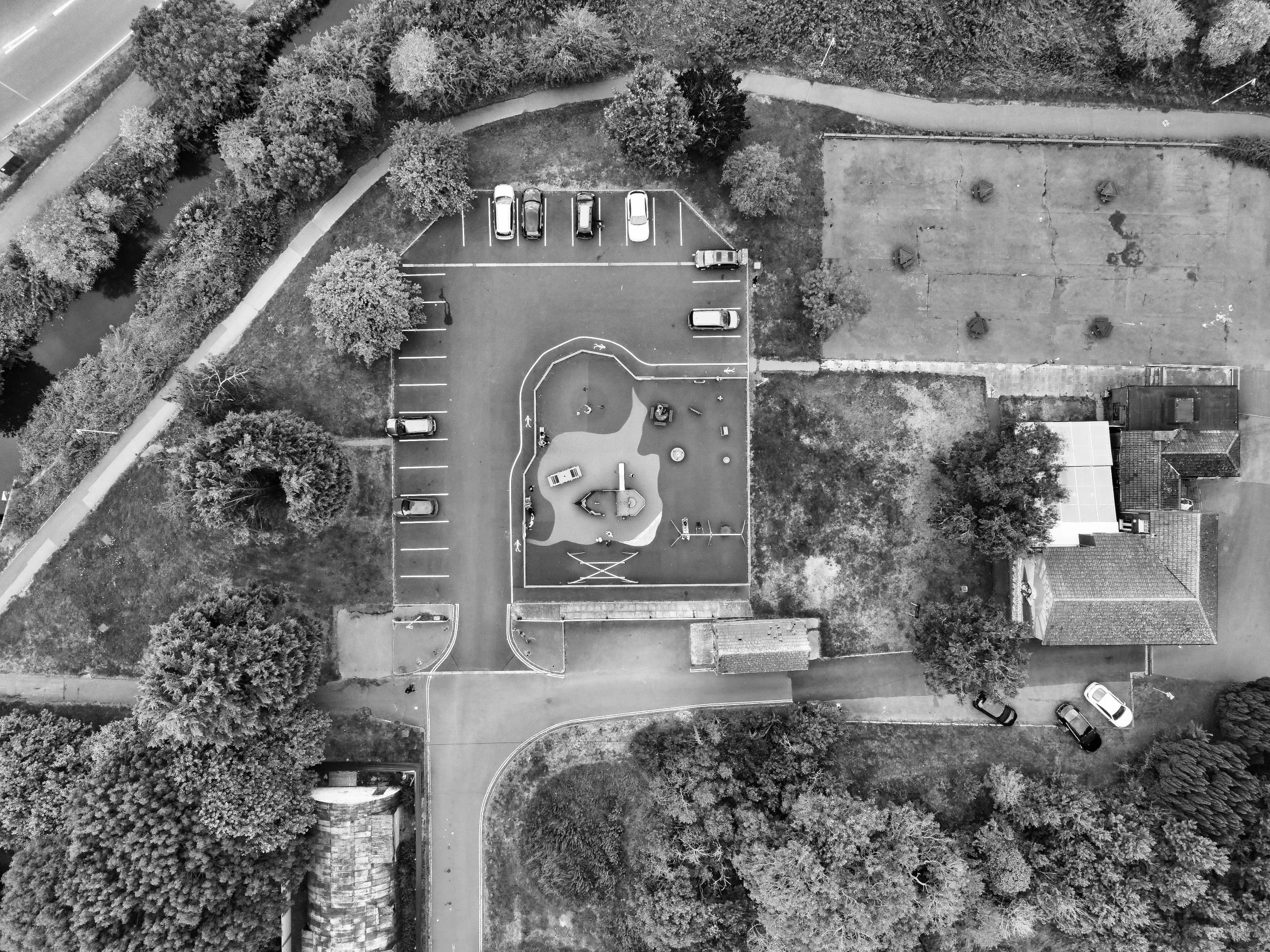 an aerial view of a park and parking lot