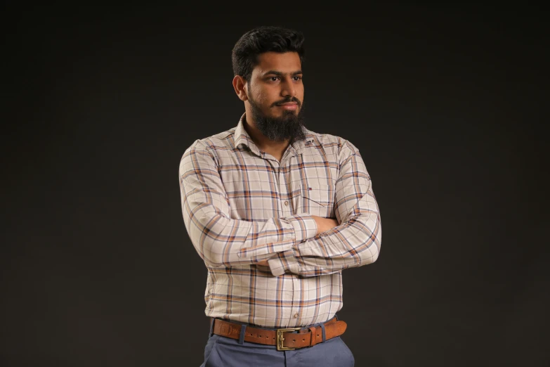 an indian man posing for a po wearing a shirt and blue pants