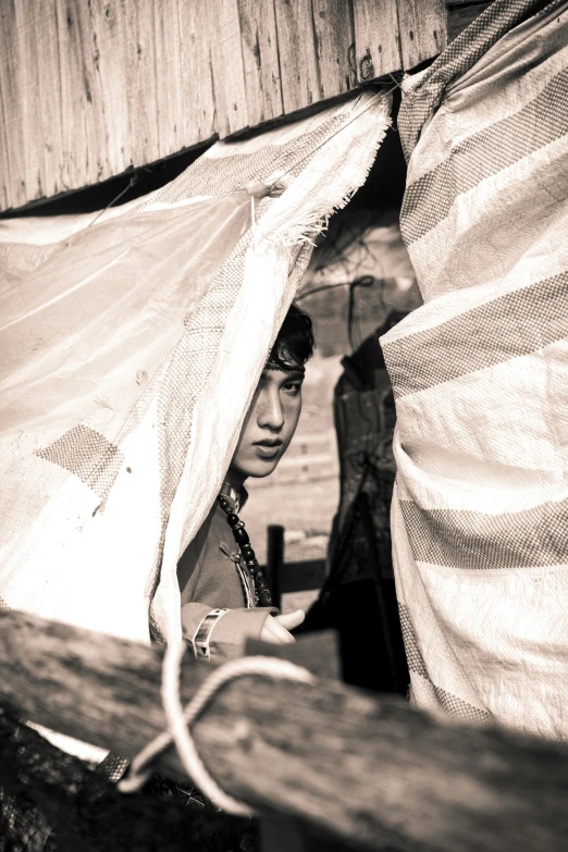 a man sitting in the corner with a large covered structure