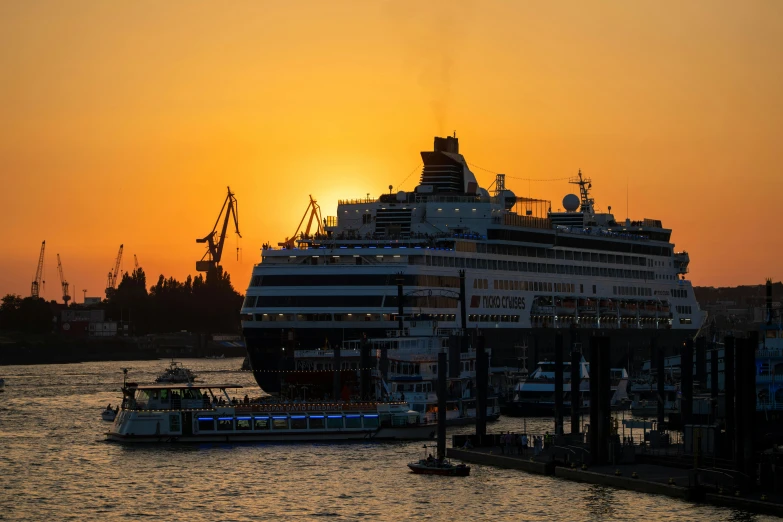 a cruise ship sailing in the water during sunset