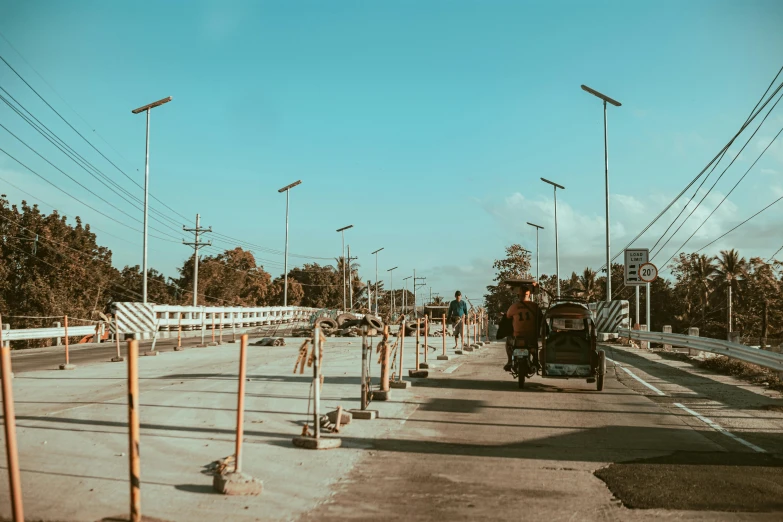 a car driving on the road with several poles behind it