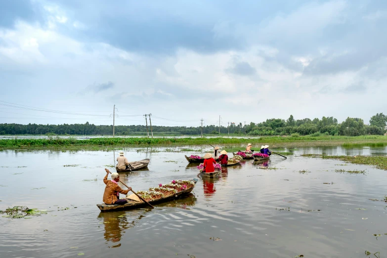 a group of people in canoes out in the water