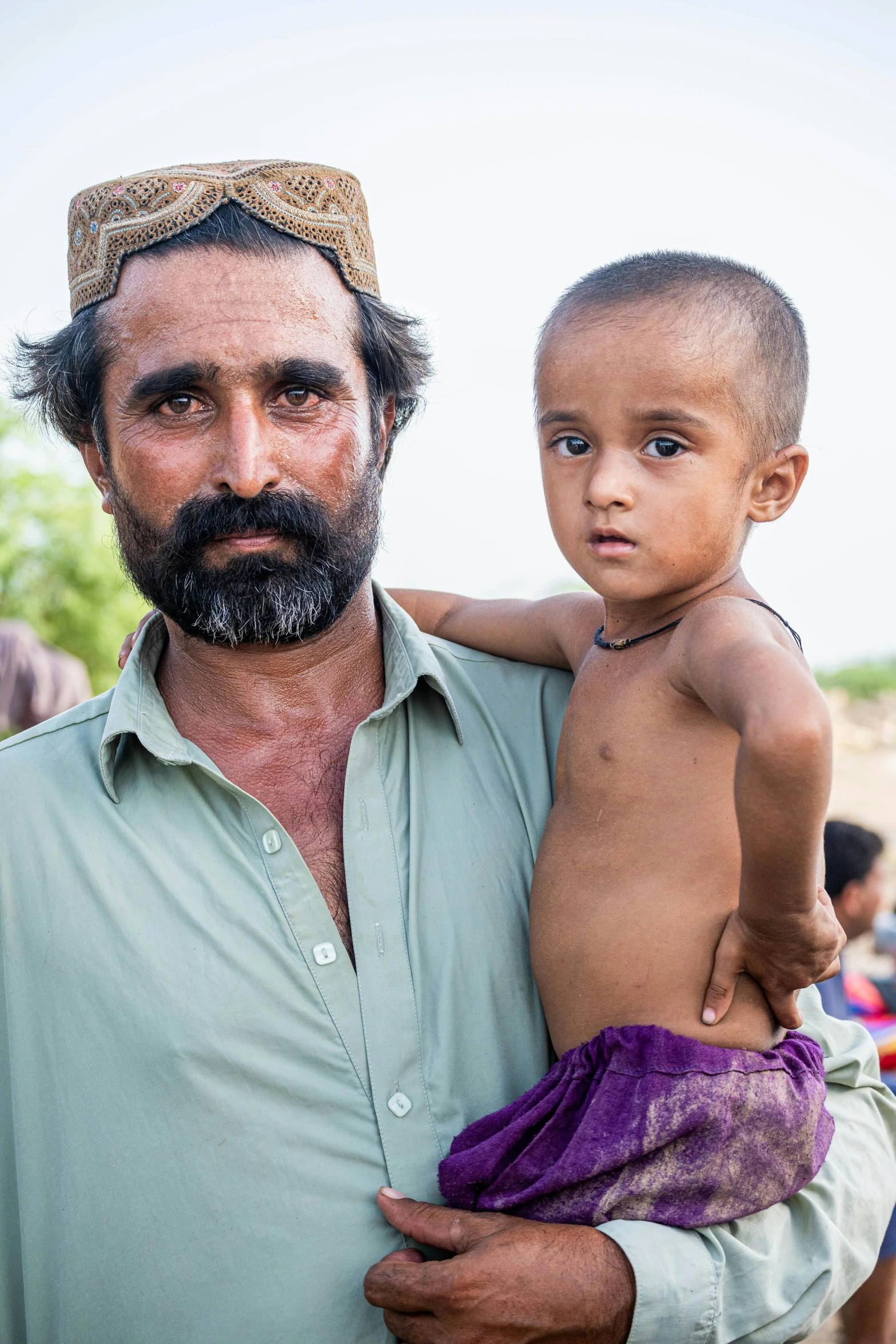 a man with a beard holding his child