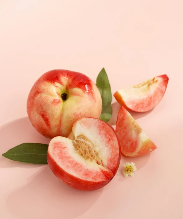 two pieces of peach sitting on top of a table