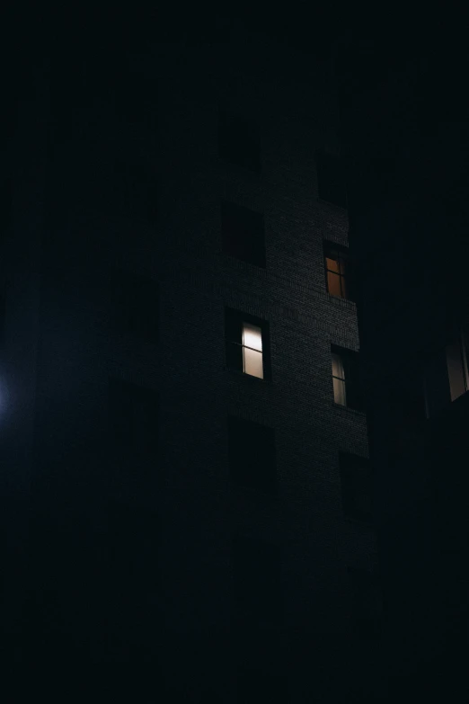 an apartment building at night with no light at the top