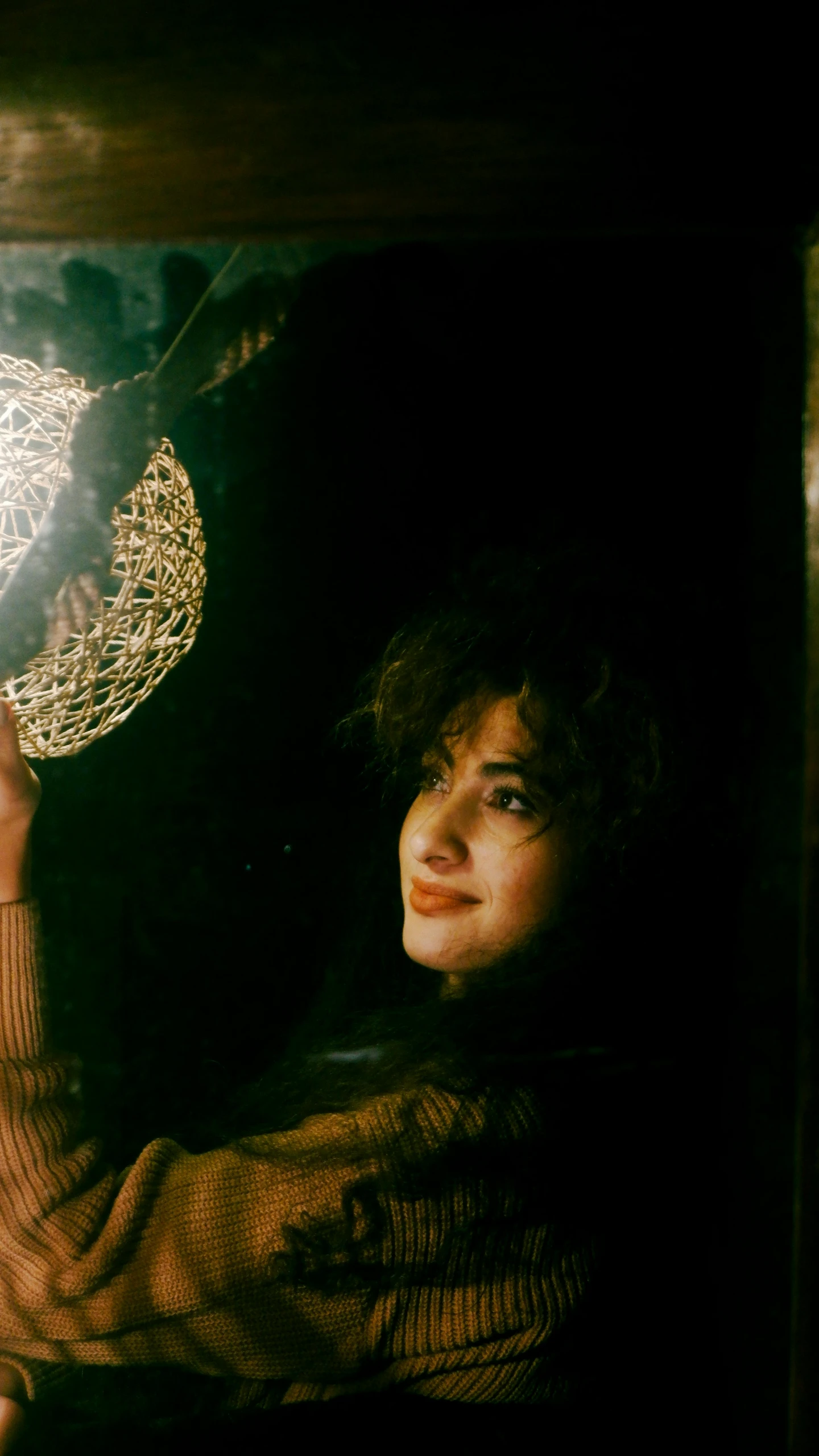 woman holding a white string - doily light bulb