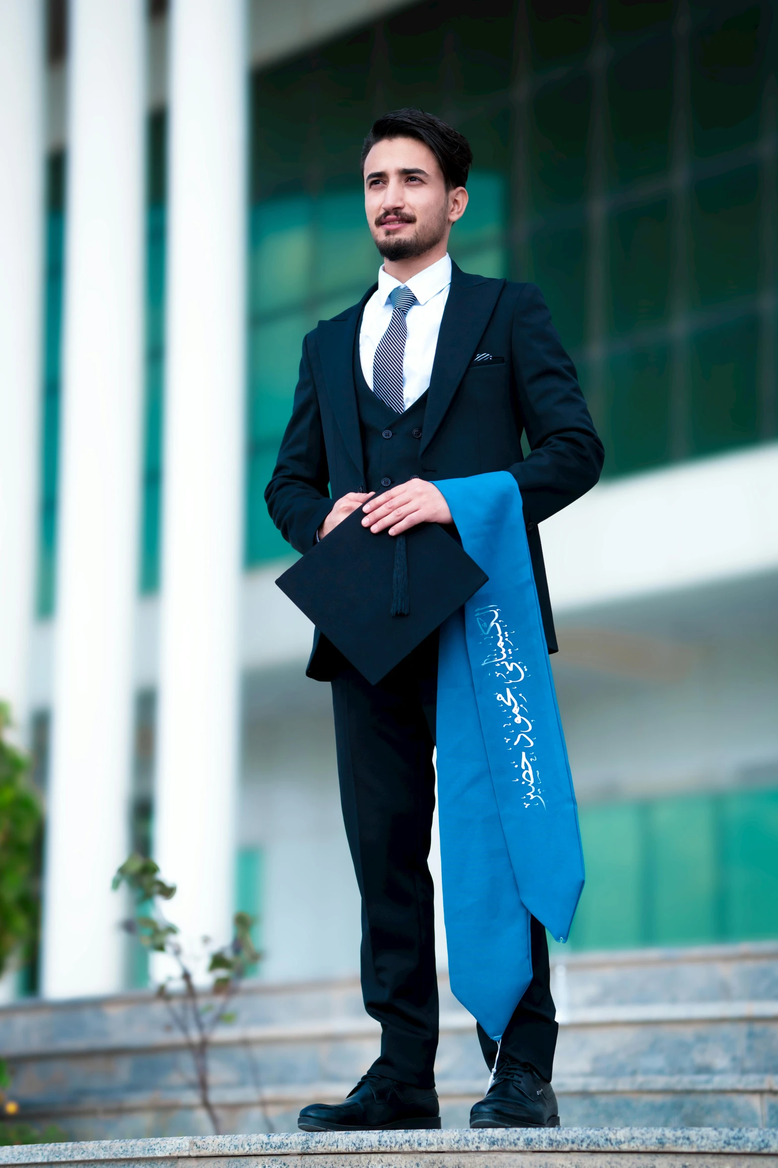 a man dressed in business attire posing for a picture