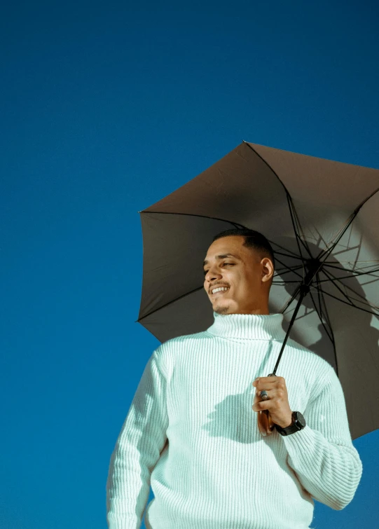 a person in white shirt holding an umbrella