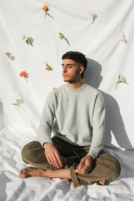 man sitting in a lotus position on the ground