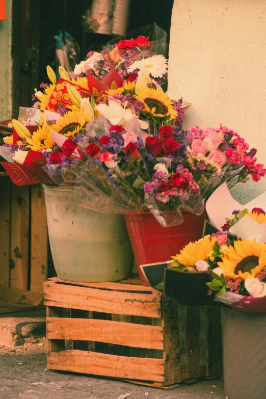 a wooden crate with some colorful flowers inside