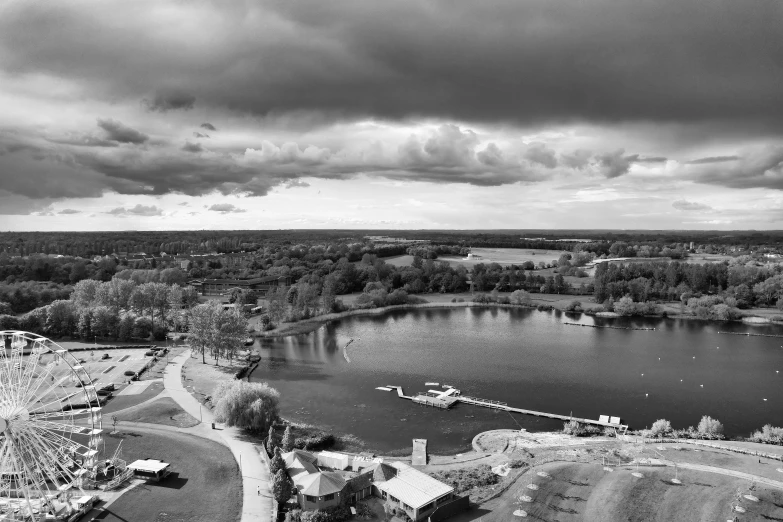 an aerial view shows clouds over a lake and park