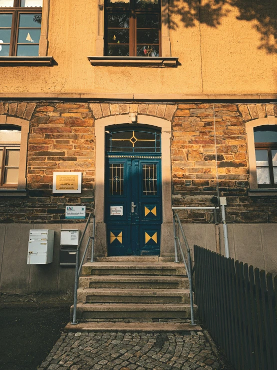 an old, stone building with windows and a door with cross design