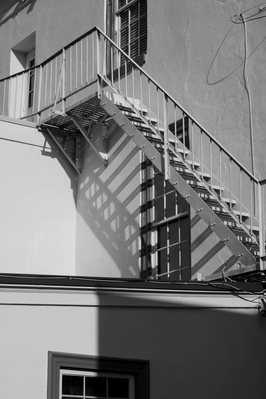 some fire escapes near a building with some windows