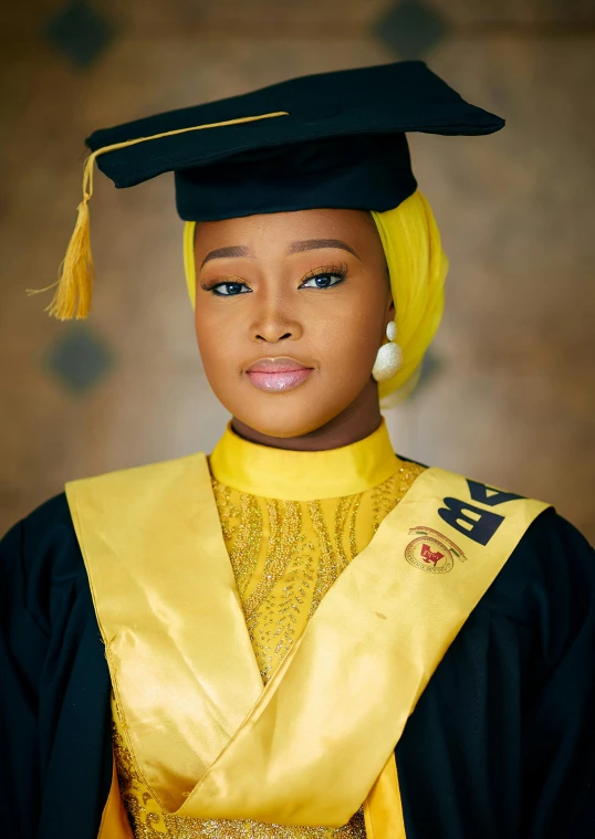 woman in yellow graduation robe and black cap