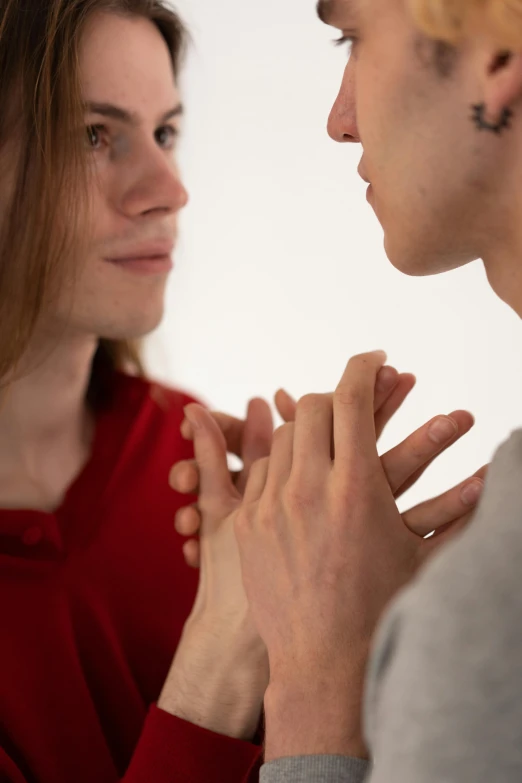 two people touching hands and looking at each other